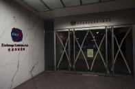 A closed sign is seen at the Hong Kong Stock Exchange after Typhoon Usagi hit Hong Kong September 23, 2013. The Hong Kong Exchange delayed the start of trading due to the powerful typhoon which hit Hong Kong and the southern China coast on Monday, killing at least 20 people on the mainland, crippling power lines and causing flooding and gale force winds. REUTERS/Tyrone Siu