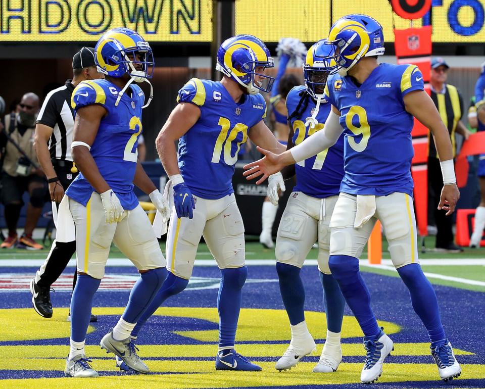 The Rams' Cooper Kupp is congratulated after grabbing a TD catch from Matthew Stafford (9) against the Lions.