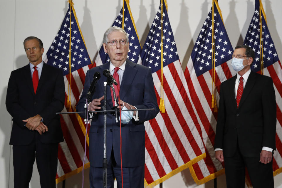 Senate Majority Leader Mitch McConnell of Ky., speaks with reporters after meeting with Senate Republicans at their weekly luncheon on Capitol Hill in Washington, Tuesday, May 19, 2020. Standing with McConnell are Senate Majority Whip John Thune, R-S.D., left, and Sen. John Barrasso, R-Wyo. (AP Photo/Patrick Semansky)