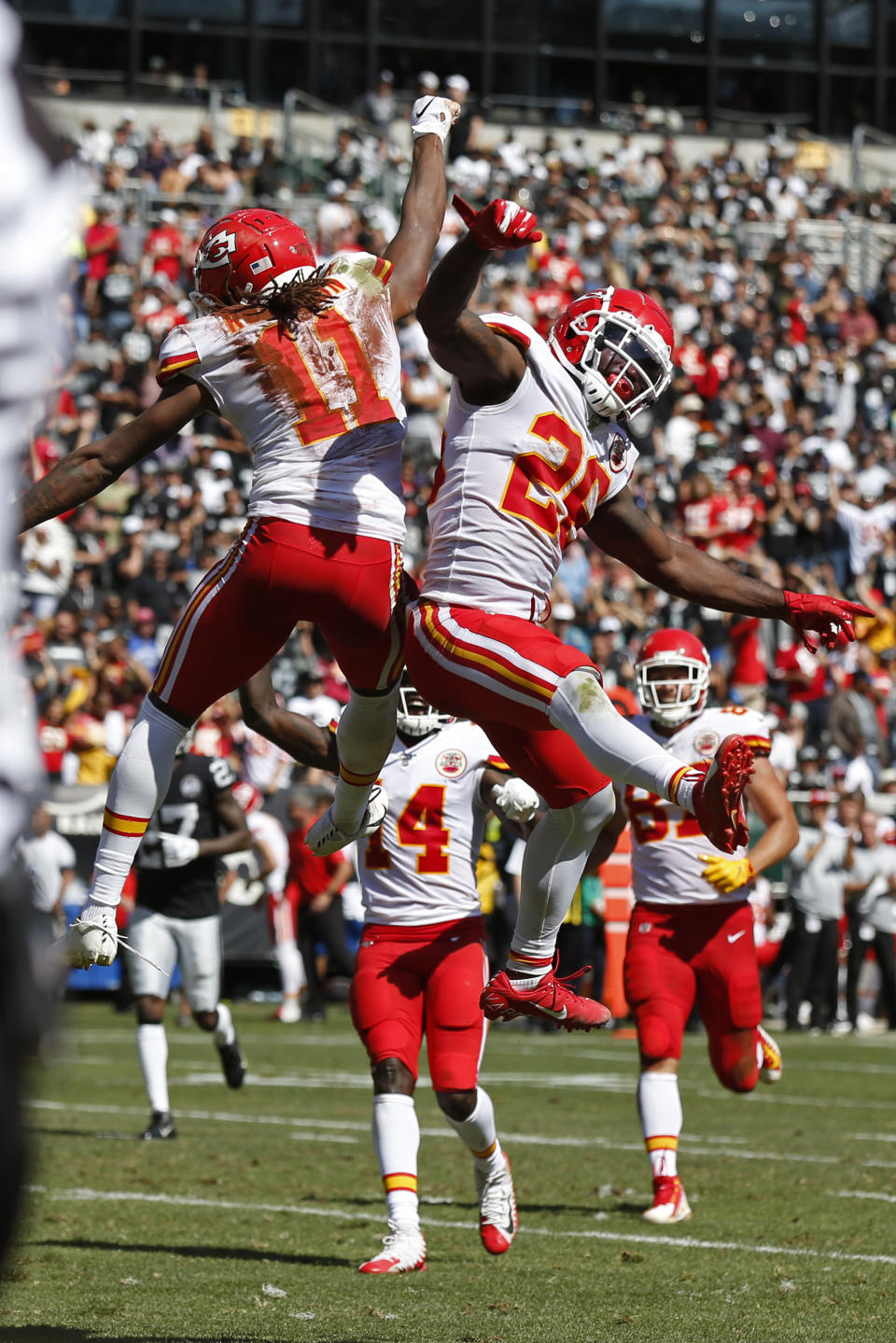 Kansas City Chiefs wide receiver Demarcus Robinson (11) is greeted by running back Damien Williams, right, after scoring a touchdown during the first half of an NFL football game against the Oakland Raiders Sunday, Sept. 15, 2019, in Oakland, Calif. (AP Photo/D. Ross Cameron)