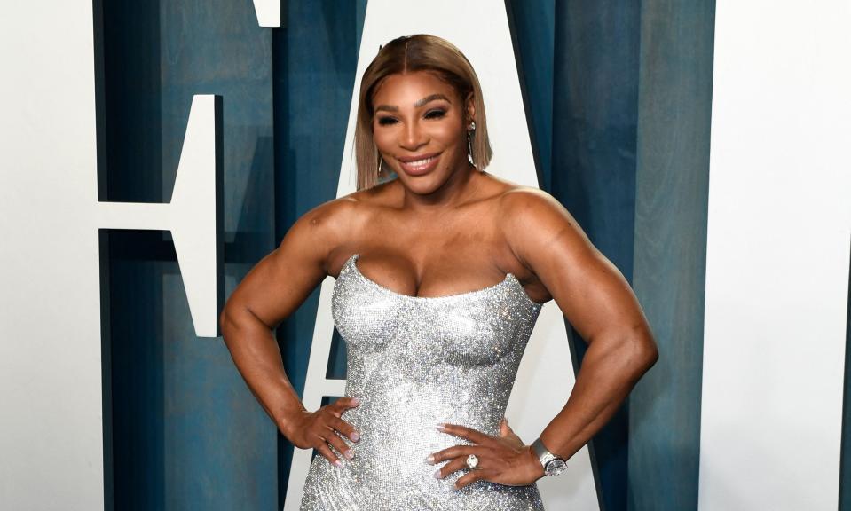 Serena Williams smiles and poses in a silver minidress at the Vanity Fair Oscars Party in March 2022
