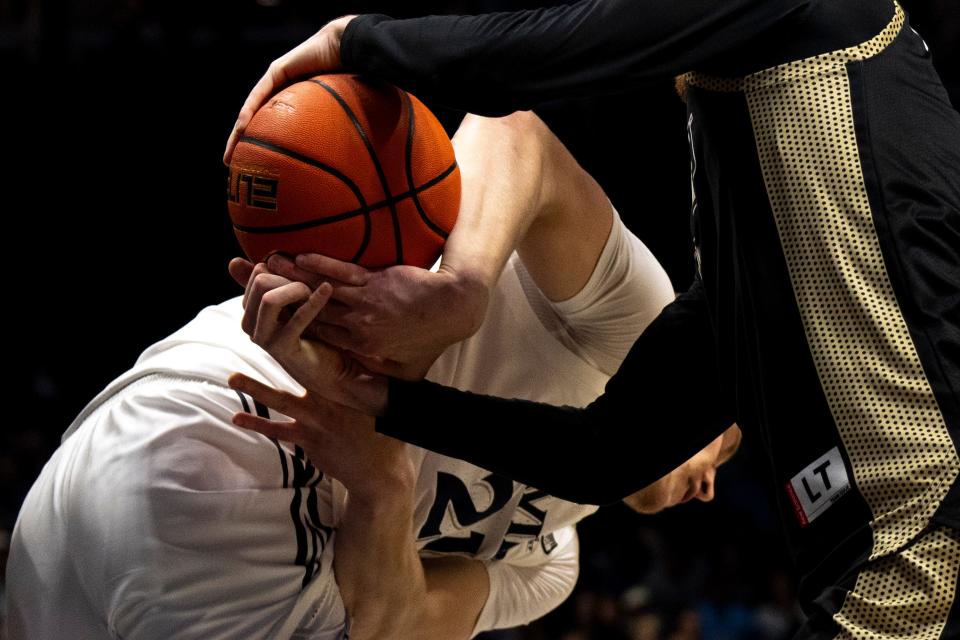 Bryant forward Connor Withers steals a ball from Xavier forward Sasa Ciani (21) during their game last week.