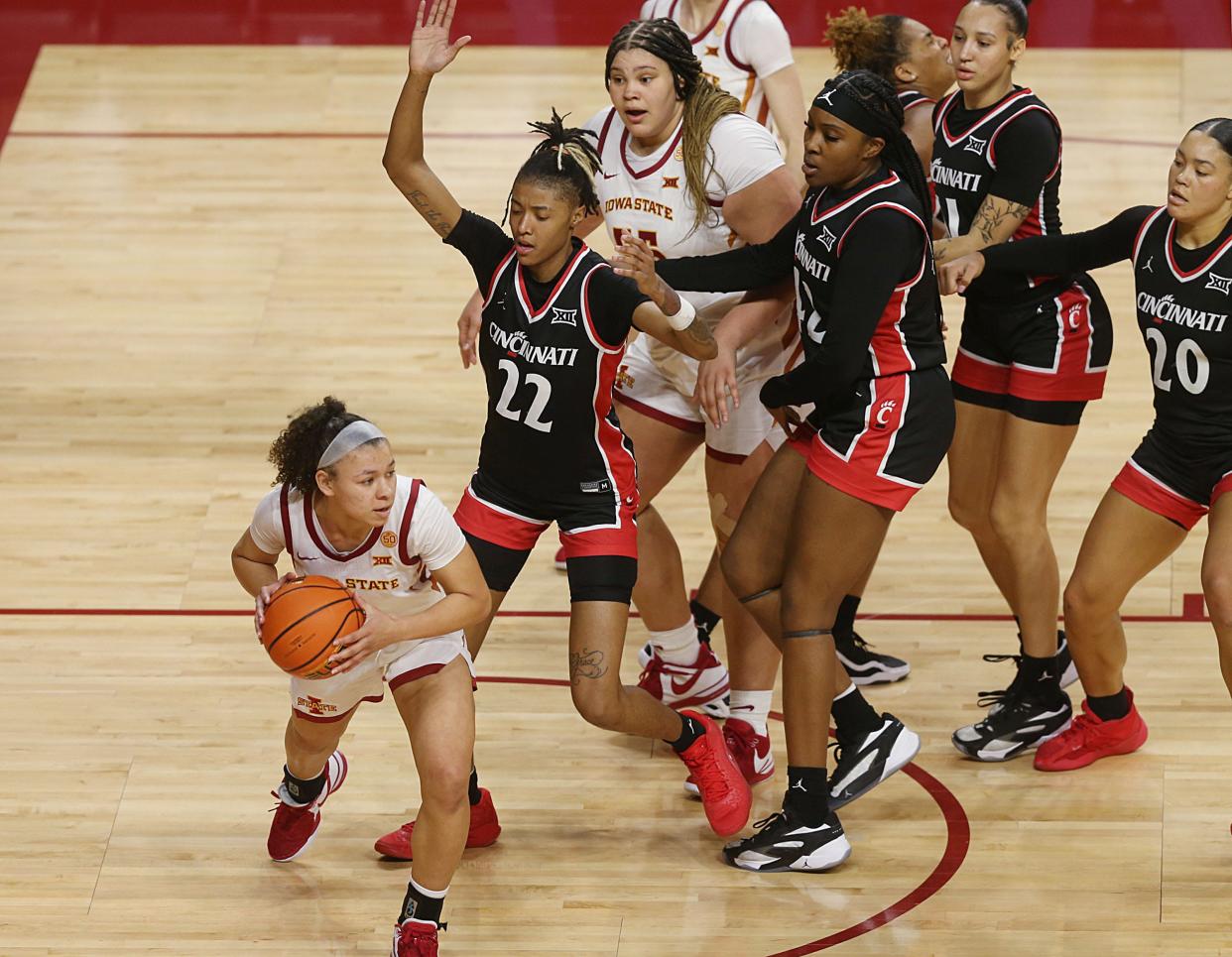 Iowa State's Arianna Jackson, left, looks to pass around Cincinnati defenders on March 2.