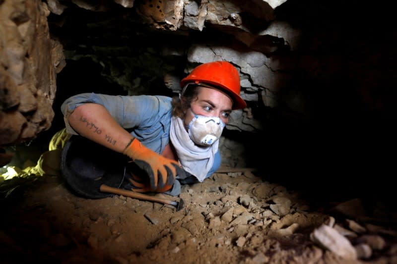 FILE PHOTO: Woman works at an archaeological dig near caves in the Qumran area