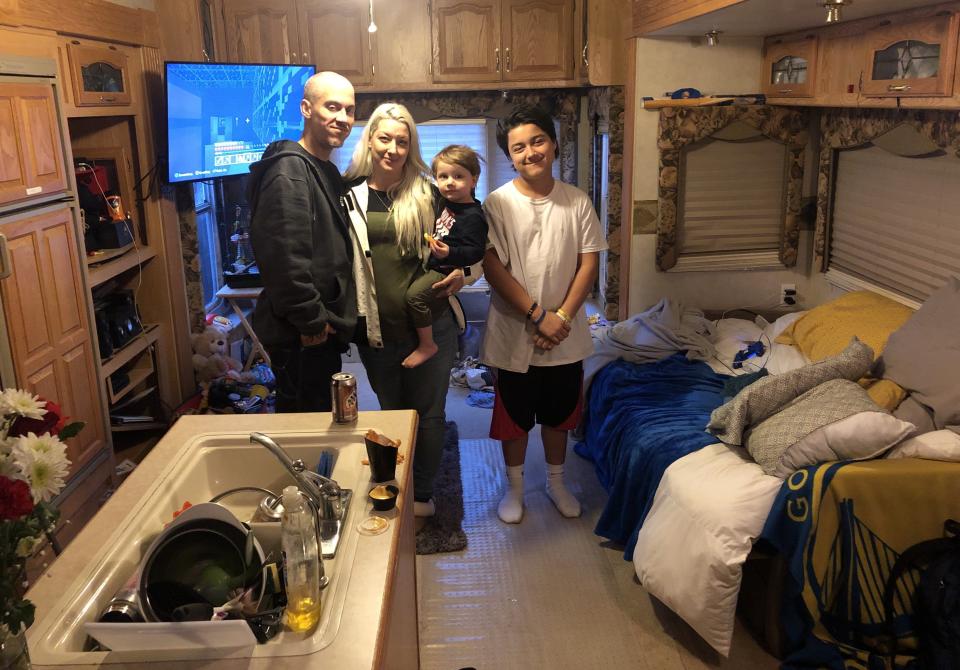 (From left) Jeremy, Kristine, Hayden and Ethan Alaways, in the trailer where they now live in her parents' yard, after losing their house in the Camp fire. &mdash; Oroville, California, Feb. 11 (Photo: Sarah Ruiz-Grossman/HuffPost)