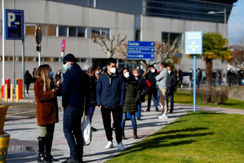 FILE PHOTO: People queue to get tested for the coronavirus disease (COVID-19) after the Christmas holiday break, amid the COVID-19 pandemic, at Doce de Octubre Hospital in Madrid