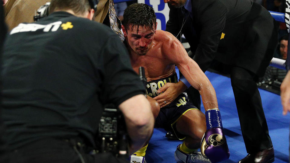 Anthony Crolla is tended to by medical staff. (Photo by Yong Teck Lim/Getty Images)