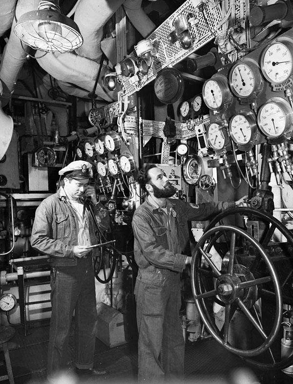 Two unidentified men in the control room of a boat