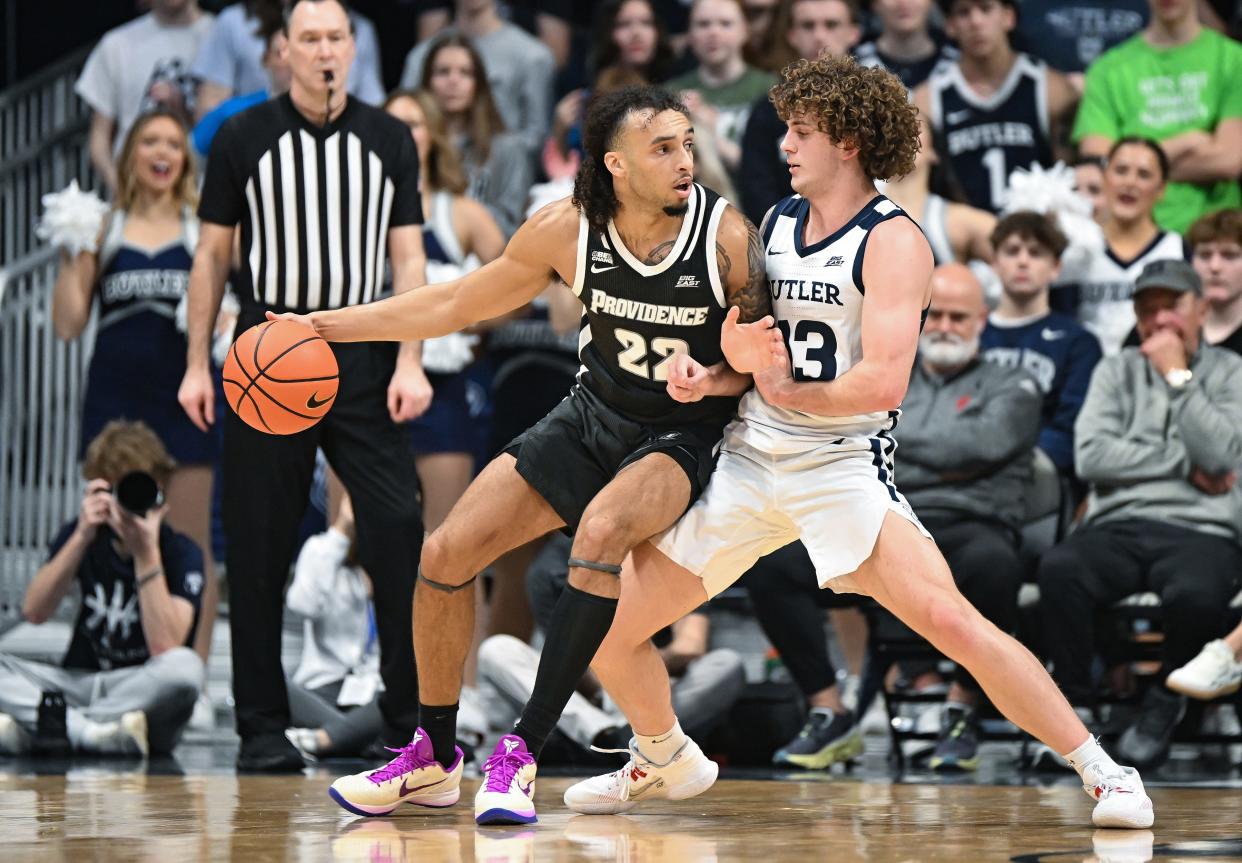 Providence guard Devin Carter, left, tries to dribble around Butler  guard Finley Bizjack during Saturday's game at Hinkle Fieldhouse. Carter has been forced to carry the Friars once Bryce Hopkins was lost for the season due to injury.