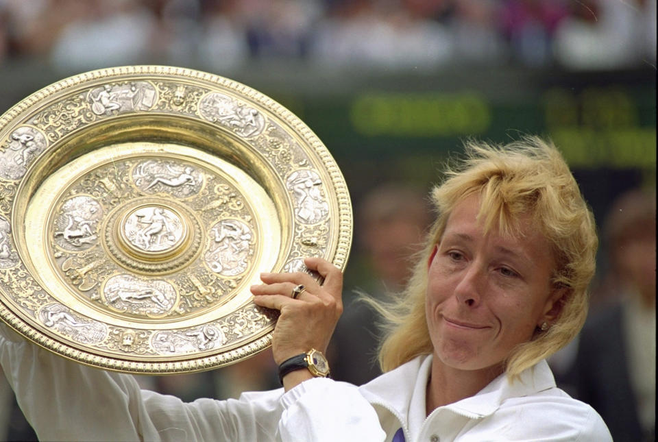 FILE - In this July 7, 1990, file photo, Martina Navratilova fights back tears as she poses with her record ninth ladies singles championship trophy at Wimbledon, after defeating Zina Garrison 6-4, 6-1. (AP Photo/Roy Letkey, FIle)