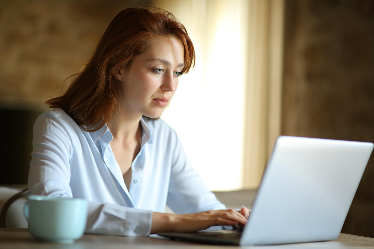 Freelance woman working with laptop at home