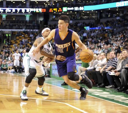 Mar 24, 2017; Boston, MA, USA; Phoenix Suns guard Devin Booker (1) controls the ball while Boston Celtics guard Isaiah Thomas (4) defends during the second half at TD Garden. Mandatory Credit: Bob DeChiara-USA TODAY Sports