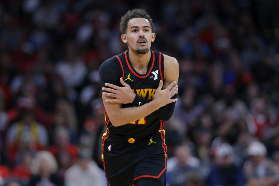 Atlanta Hawks guard Trae Young gestures in reaction to his 3-point shot against the Houston Rockets during the second half of an NBA basketball game Wednesday, Dec. 20, 2023, in Houston. (AP Photo/Michael Wyke)