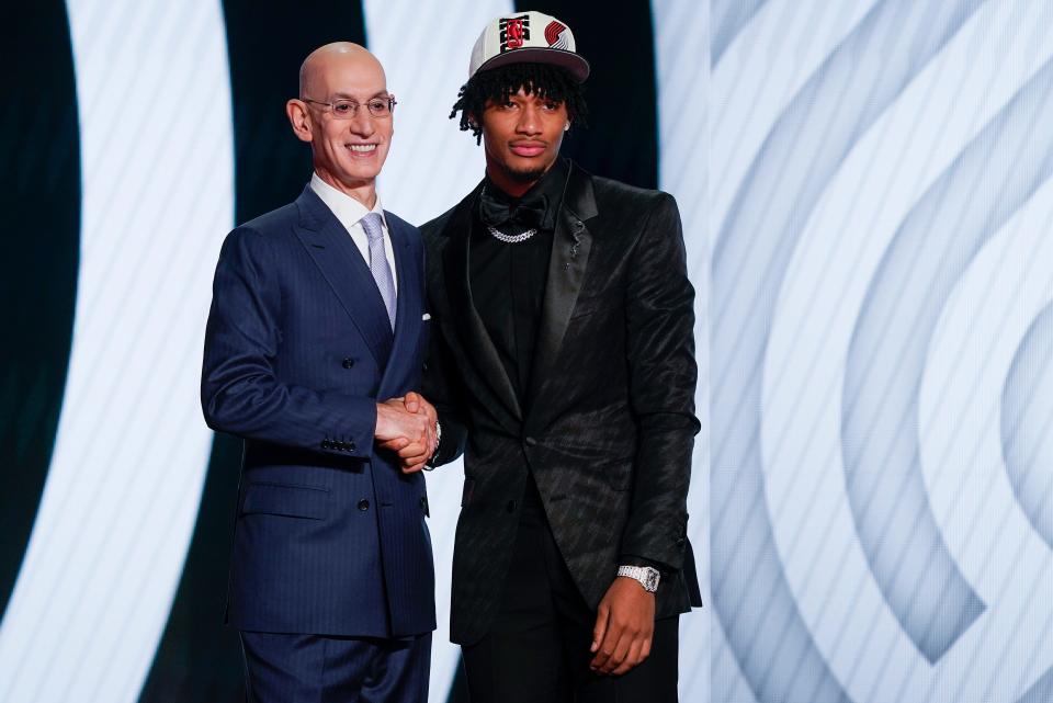 Shaedon Sharpe, right, shakes hands with NBA Commissioner Adam Silver after being selected seventh overall by the Portland Trailblazers in the NBA basketball draft, Thursday, June 23, 2022, in New York. (AP Photo/John Minchillo)