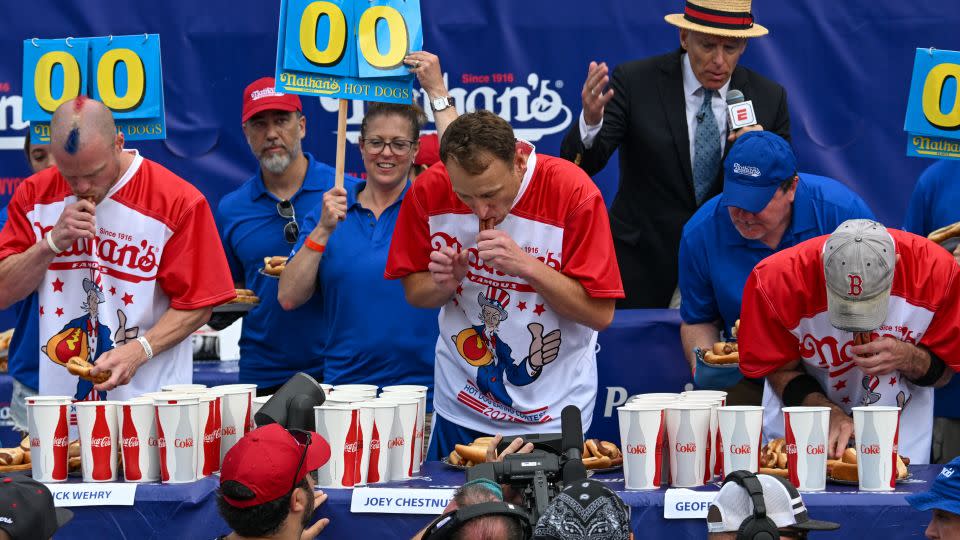 Defending champion Joey Chestnut, center, competes in the 2023 Nathan's Famous Fourth of July Hot Dog Eating Contest on July 4, 2023, on New York's Coney Island. He won again. - Alexi J. Rosenfeld/Getty Images North America/Getty Images