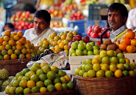 Fruit vendors wait for customers at a market in Mumbai, India, December 12, 2017. REUTERS/Shailesh Andrade