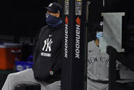 FILE - In this Tuesday, Sept. 29, 2020, file photo, New York Yankees manager Aaron Boone watches from the dugout in the sixth inning of Game 1 of an American League wild-card baseball series against the Cleveland Indians in Cleveland. (AP Photo/David Dermer, File)