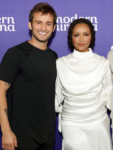 <p>Chelsea Lauren/Shutterstock </p> Kat Graham and Bryant Wood at the Modern Nirvana Conference in 2021