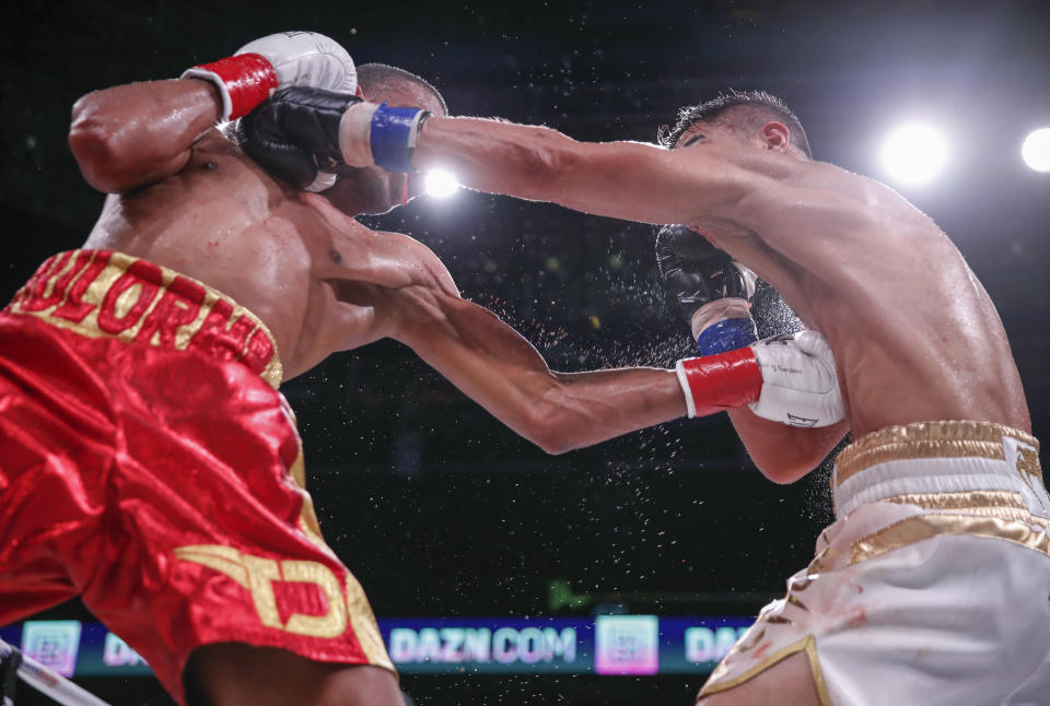 Thomas Dulorme, left, trades punches with Jessie Vargas during a boxing bout Saturday, Oct. 6, 2018, in Chicago. (AP Photo/Kamil Krzaczynski)