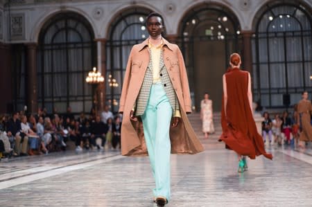 Models present creations during the Victoria Beckham catwalk show at London Fashion Week in London