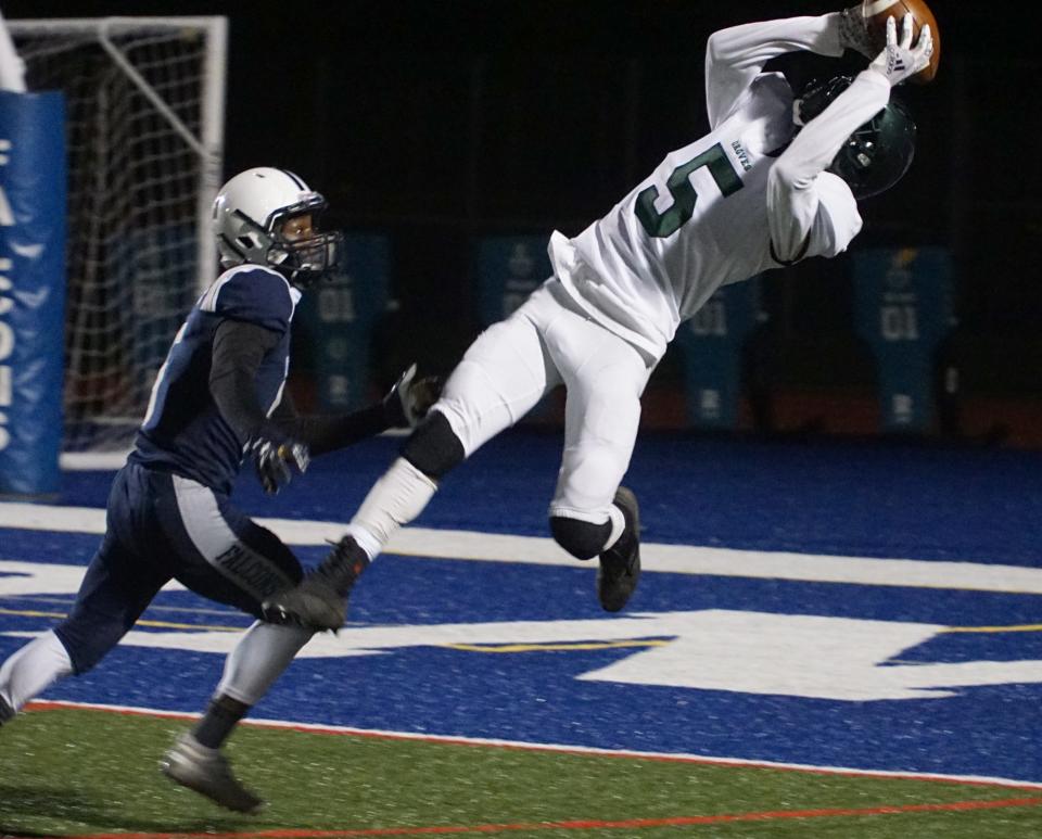     Groves' Jaden Mangham hauls in a fourth quarter touchdown.                      