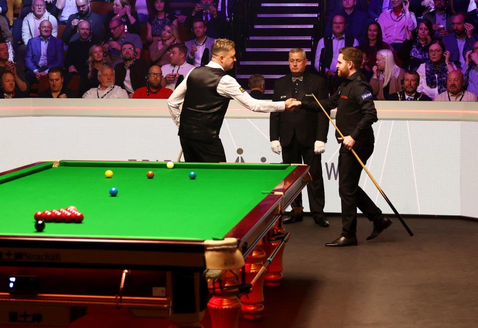 Kyren Wilson and Jak Jones shake hands before the evening session (Action Images via Reuters)