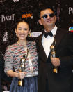 Chinese actress Zhang Ziyi, left, and Hong Kong director Wong Kar-wai pose after winning the Best Actress award and the Best Director award of their movie “The Grandmaster” at the 33rd Hong Kong Film Awards in Hong Kong Sunday, April 13, 2014. (AP Photo/Kin Cheung)