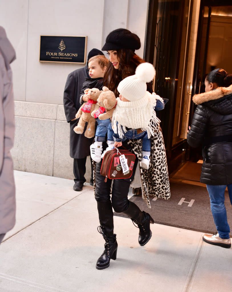 <p>Amal looks casual chic in a cheetah print coat, black leather pants, lace up boots, and a black cap as she leaves the Four Seasons Hotel with twins Alexander and Ella Clooney. </p>