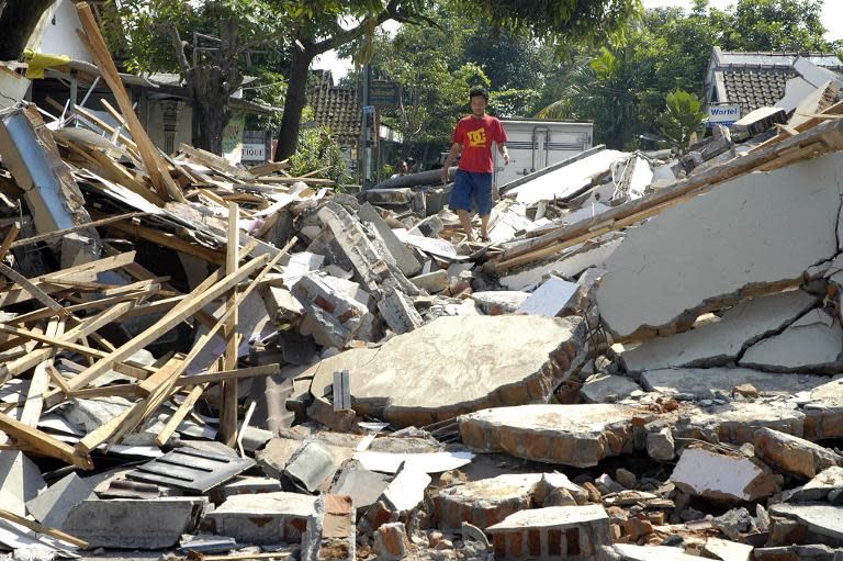 A resident checks his damaged house following an earthquake in Yogyakarta, Indonesia, May 27, 2006