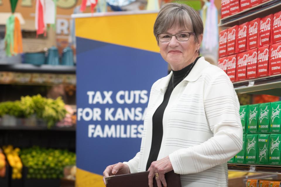 Gov. Laura Kelly stands by signage before speaking at a ceremonial bill signing of the food sales tax cut last month at Mi Pueblito Meat Market, 621 S.E. Swygart St.