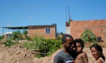 Garbage collectors Adilson Farias, 31 (L) and his wife Rosana de Paula, 37, who work with Coopama, are pictured with their grandchild Ana Mikaely, 3, in Duque de Caxias near Rio de Janeiro