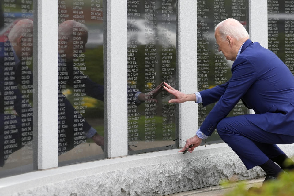 President Joe Biden visits the War Memorial in Scranton, Pa., Wednesday, April 17, 2024, and touches the wall near his uncle's name, Ambrose J Finnegan Jr., who died in WWII. (AP Photo/Alex Brandon)