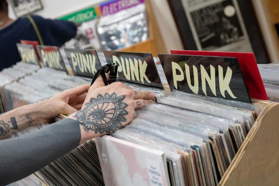 Laura Jane Grace peruses through the punk section of records at Sunshine Records in Gainesville, Fla., on April 14, 2023.