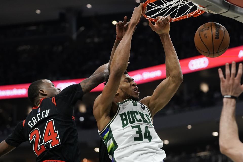 Milwaukee Bucks' Giannis Antetokounmpo dunks past Chicago Bulls' Javonte Green during the first half of Game 1 of their first round NBA playoff basketball game Sunday, April 17, 2022, in Milwaukee. (AP Photo/Morry Gash)