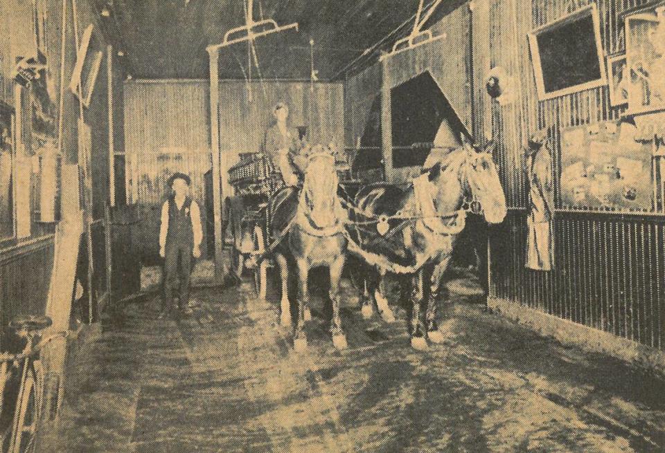 This photo shows one side of the interior of the old San Luis Obispo city hall when it housed the fire department. Note the racks which held harnesses above the horses, ready for a quick hitch up.