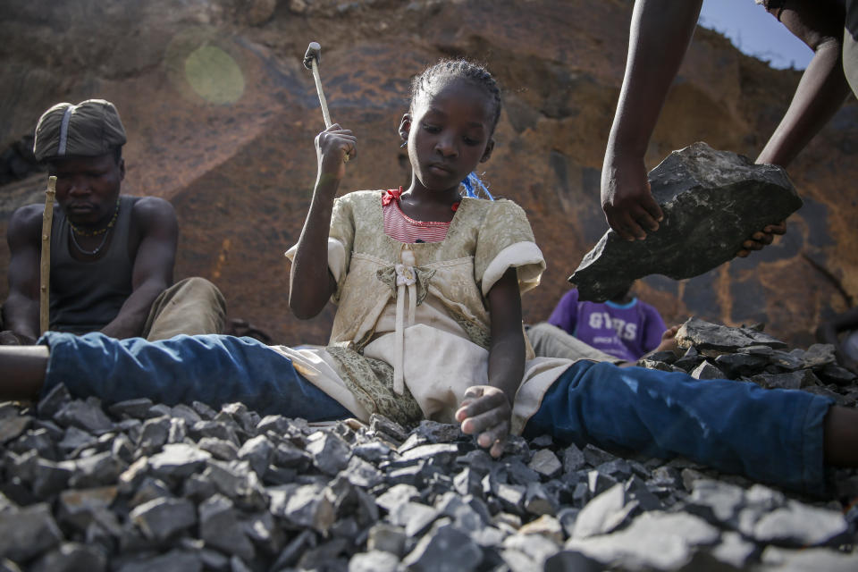 Irene Wanzila, 10, works breaking rocks with a hammer along with her younger brother, older sister and mother, who says she was left without a choice after she lost her cleaning job at a private school when coronavirus pandemic restrictions were imposed, at Kayole quarry in Nairobi, Kenya Tuesday, Sept. 29, 2020. The United Nations says the COVID-19 pandemic risks significantly reducing gains made in the fight against child labor, putting millions of children at risk of being forced into exploitative and hazardous jobs, and school closures could exacerbate the problem. (AP Photo/Brian Inganga)