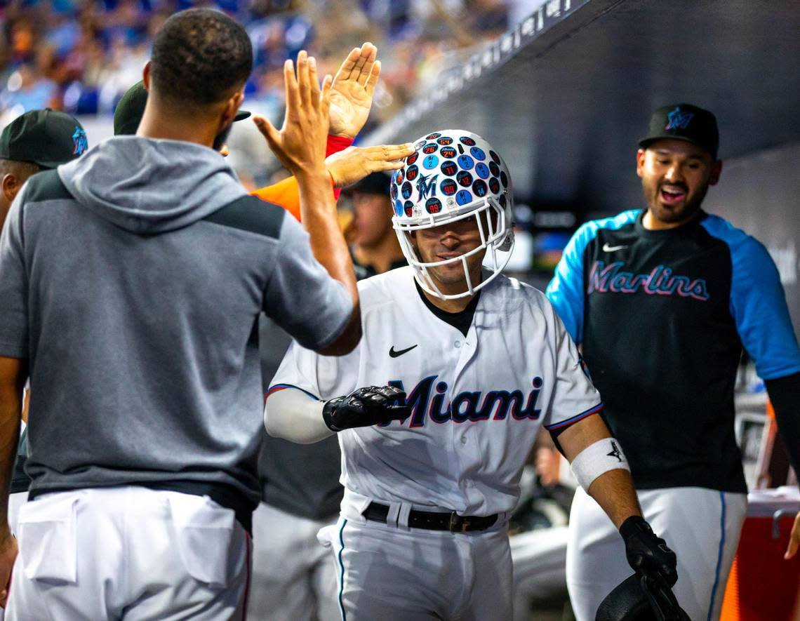 Miami Marlins catcher Nick Fortes (54) reacts with teammates inside the home dugout after homering during the second inning of an MLB game against the San Diego Padres at loanDepot park in the Little Havana neighborhood of Miami, Florida, on Tuesday, August 16, 2022