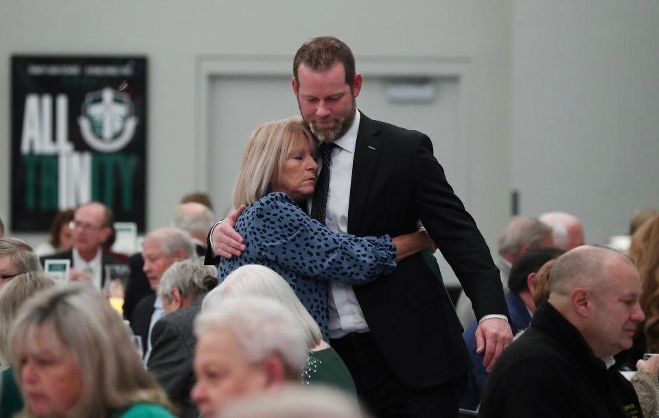 Former Trinity High School and U of L QB Brian Brohm embraces his aunt, Laura Blair, just before the Trinity High School Hall of Fame Dinner, where Brian and his dad Oscar were inducted Thursday night. Blair is Oscar's sister.