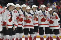 Team Canada players pose with their medals after beating the United States in the final at the IIHF Women's World Hockey Championships in Utica, N.Y., Sunday, April 14, 2024. (AP Photo/Adrian Kraus)