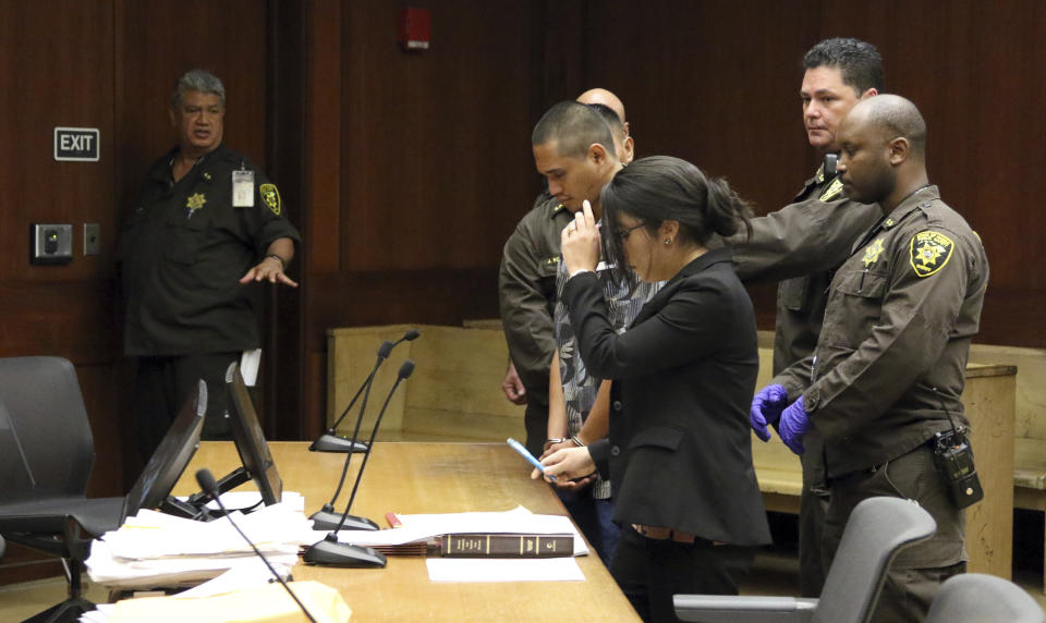 Standing handcuffed and surrounded by deputy sheriffs, Alins Sumang stands next to Deputy Public Defender Sarah Nishioka in court Thursday, Jan. 31, 2019 in Honolulu. Prosecutors say Sumang recklessly caused the deaths of Casimir Pokorny of Pennsylvania, Reino Ikeda of Japan and William Lau of Honolulu. Police say speed and alcohol appeared to factors in Monday's crash. Police Chief Susan Ballard says it's one of Honolulu's deadliest pedestrian crashes. (AP Photo/Jennifer Sinco Kelleher).
