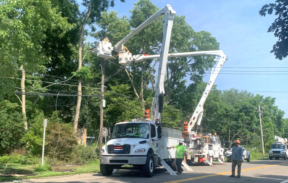 Crews work to repair downed power lines and remove fallen trees Tuesday, July 16, 2024 on Maple Avenue near Notre Dame High School in the Town of Southport. The damage was part of a path of destruction left by violent thunderstorms that rocked the region Monday.