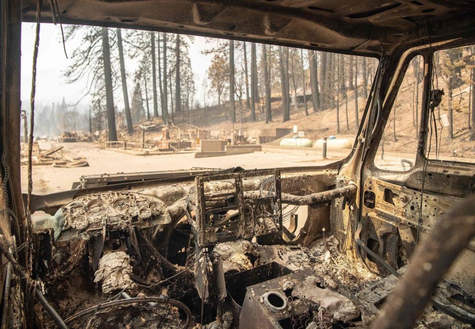 The inside of a burned fire engine smolders in a decimated downtown Greenville, California during the Dixie fire on Aug. 5, 2021.