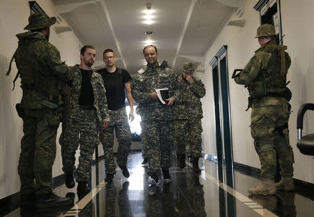 Pavel Gubarev (C, front), one of the leaders of the self-proclaimed Donetsk People's Republic, walks to attend a news conference in the eastern Ukrainian city of Donetsk, July 9, 2014. REUTERS/Maxim Zmeyev