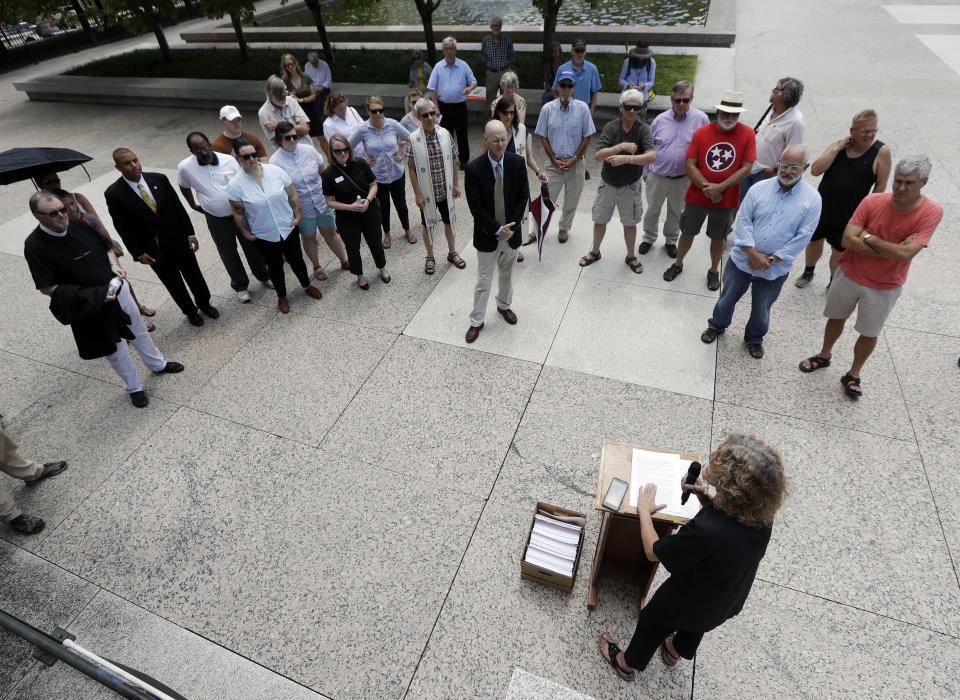 Rev. Stacy Rector, bottom, speaks during a protest against the death penalty Tuesday, Aug. 7, 2018, in Nashville, Tenn. Attorneys are asking the U.S. Supreme Court for a stay of execution for convicted child killer Billy Ray Irick after the Tennessee Supreme Court and governor decided against a delay. (AP Photo/Mark Humphrey)