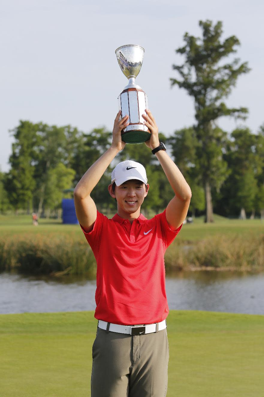 Noh Seung-yul, of South Korea, holds up his trophy after winning the Zurich Classic golf tournament at TPC Louisiana in Avondale, La., Sunday, April 27, 2014. (AP Photo/Bill Haber)