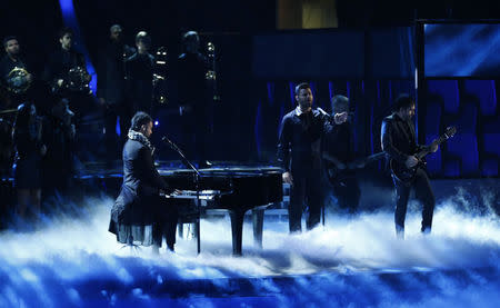 Mexican rock band Camila perfoms "Perdon" with Ricky Martin. REUTERS/Mike Blake