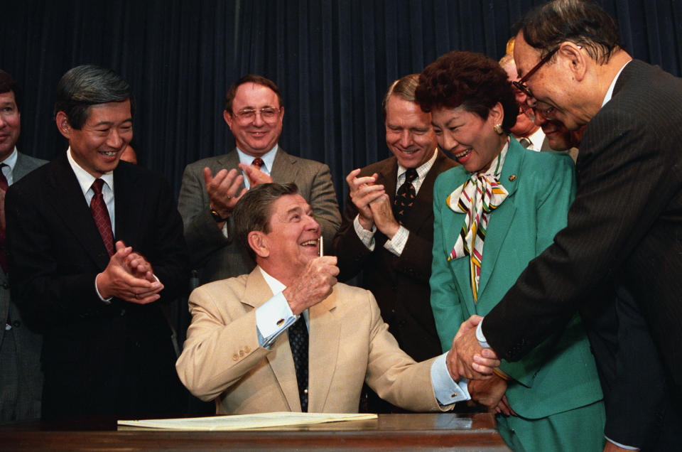 President Ronald Reagan signs the Civil Liberties Act of 1988, acknowledging that the United States really didn't need to incarcerate 120,000 Japanese-Americans in so-called internment camps.