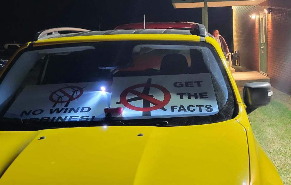 Anti-wind signs are displayed on the dashboard of a vehicle outside Fremont Township Hall on Tuesday, Nov. 22, 2022.
