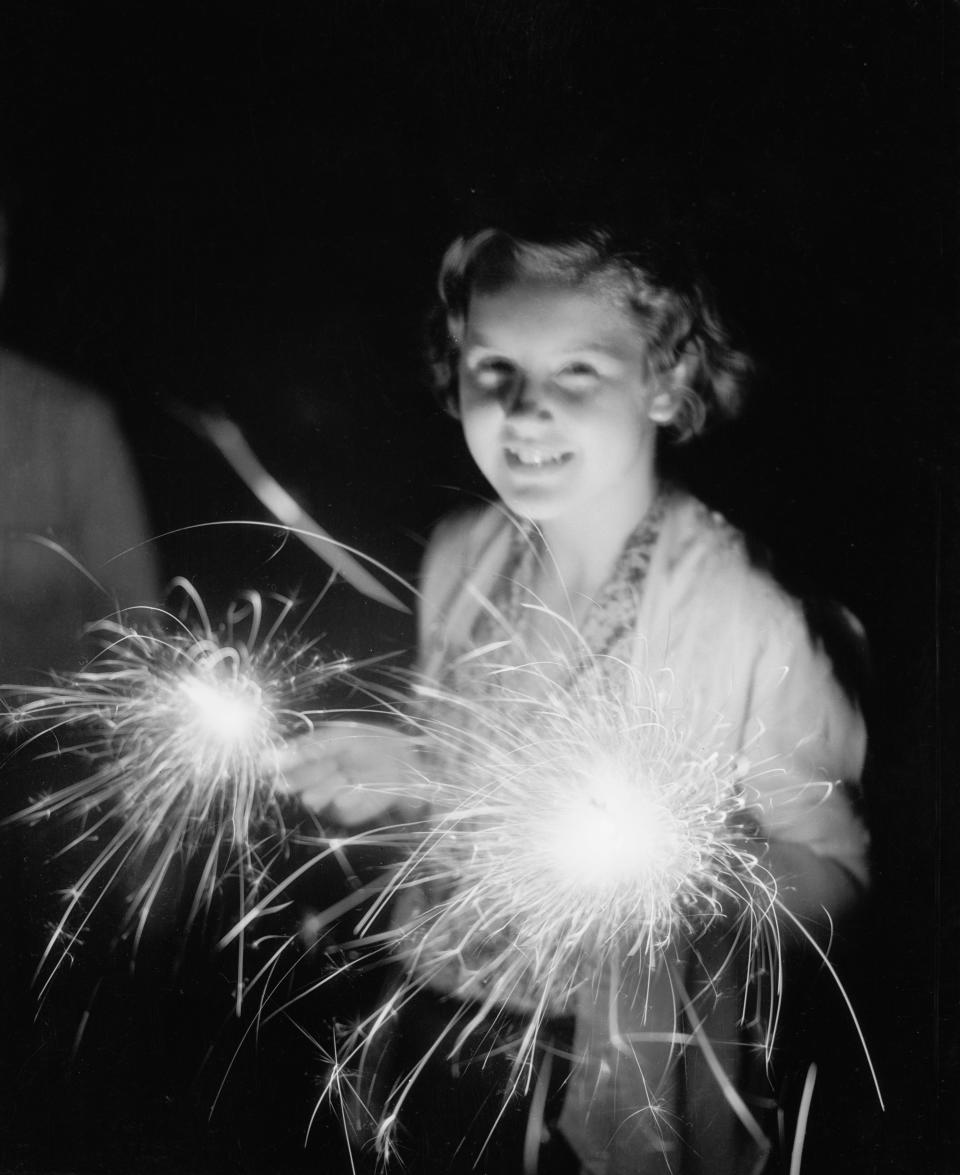 <p>Girl with sparklers, 1930. (Photo: Bettmann Archive/Getty Images) </p>