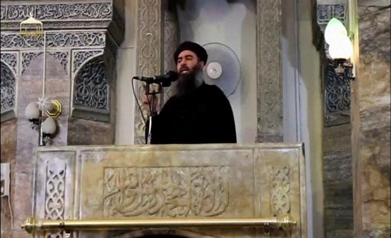 FILE PHOTO: A man purported to be the reclusive leader of the militant Islamic State Abu Bakr al-Baghdadi making what would have been his first public appearance, at a mosque in the centre of Iraq's second city, Mosul, according to a video recording posted on the Internet on July 5, 2014, in this still image taken from video.      REUTERS/Social Media Website via Reuters TV/File Photo